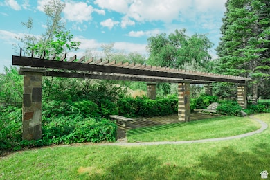 Surrounding community with a pergola and a lawn