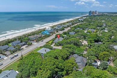 Aerial view of property and surrounding area featuring expansive coastline