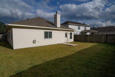 Back view.  Home has fenced back yard for kids or pets.
