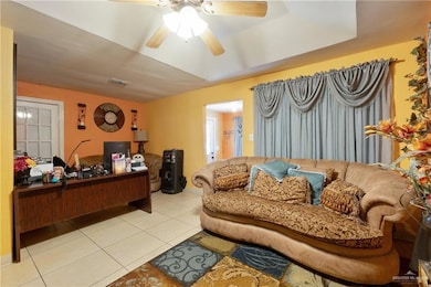 Home office with light tile patterned flooring and ceiling fan