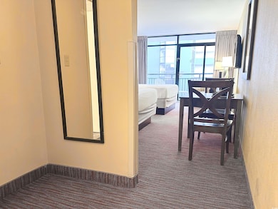 Hall featuring dark colored carpet