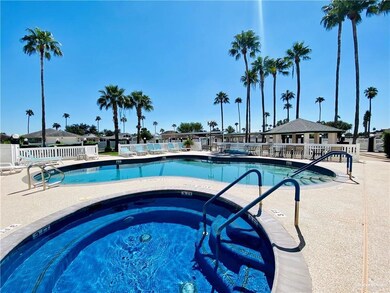 Community pool with a patio and a hot tub