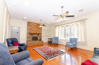 Living area featuring a brick fireplace, a decorat