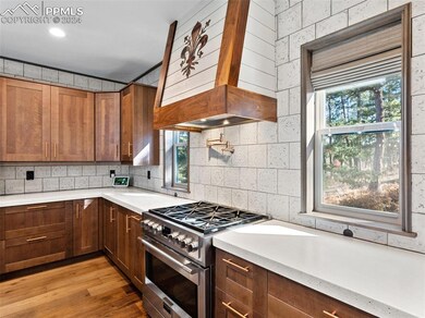 Kitchen with high end stove, custom range hood, a 