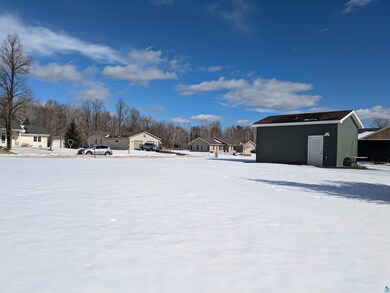 Snowy yard featuring a residential view