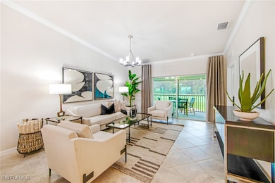 Living area featuring an inviting chandelier, ornamental molding, visible vents, light tile patterned flooring, and baseboards