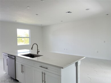 Kitchen with visible vents, a sink, white cabinets