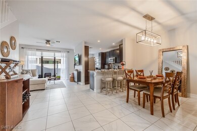 Dining space with a ceiling fan and light tile pat