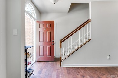Entrance foyer with dark hardwood / wood-style flo