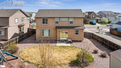 Fully fenced backyard with mature landscaping and 