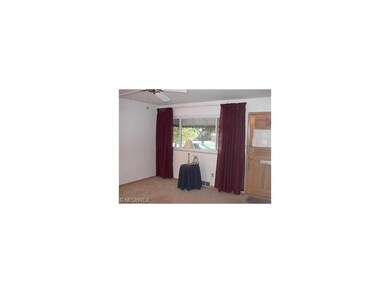 This third living room photo shows the ceiling fan