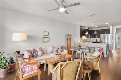 Living area with a ceiling fan, recessed lighting