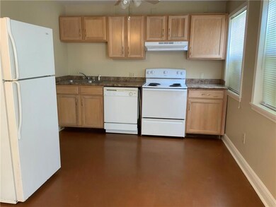 Furnished Kitchen has refrigerator, electric stove and dishwasher.