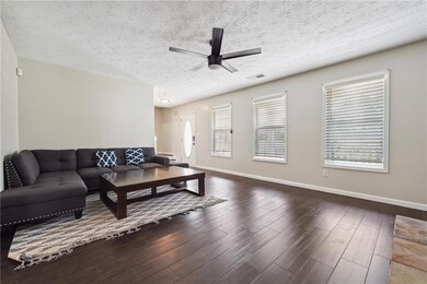 Living room featuring baseboards, visible vents, a