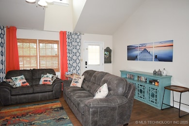 Living area featuring wood finished floors, vaulte
