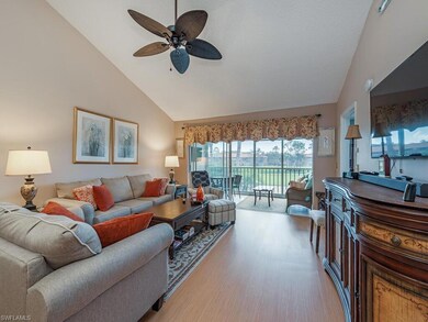 Living room featuring ceiling fan, light wood-type