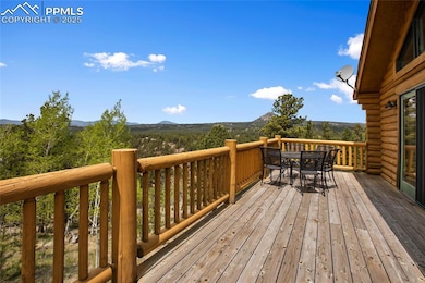 Deck with outdoor dining space and a mountain view