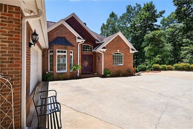View of front of home with brick siding and a shingled roof