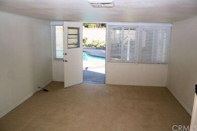 Family room leading out to backyard and pool area.