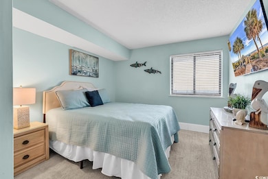 Carpeted bedroom with a textured ceiling