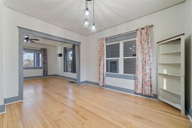 Unfurnished room featuring visible vents, baseboards, and hardwood / wood-style floors