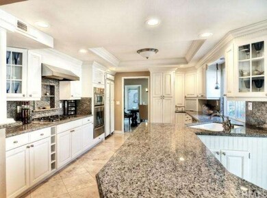 Open kitchen with recessed lighting, custom island