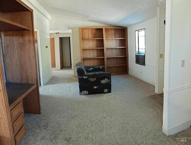 Unfurnished room featuring vaulted ceiling, carpet, and crown molding