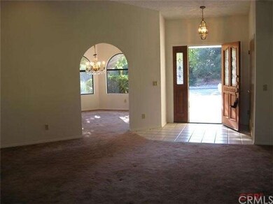 Living room looking at front door and into Formal 