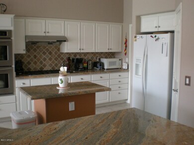 Large kitchen with granite slab counters