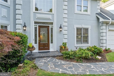 Beautiful stone walkway to the striking leaded glass entryway!