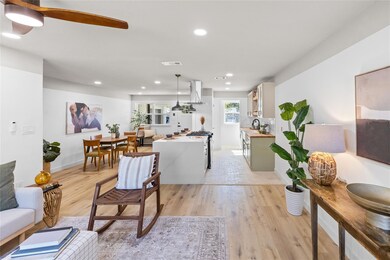 Living room with ceiling fan, light wood-type floo