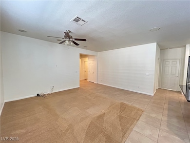 Spare room featuring light tile patterned floors,