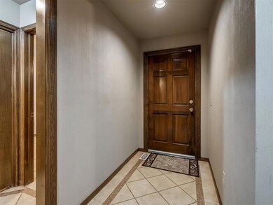 Doorway with light tile patterned floors