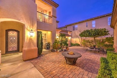 View of patio / terrace with a balcony, a fire pit