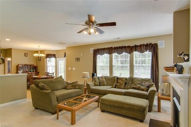 Den opens to kitchen and breakfast room