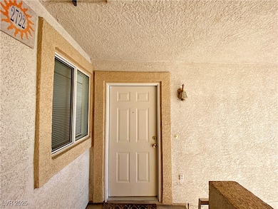 Property entrance featuring stucco siding