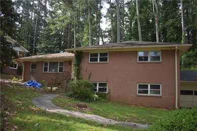 View of home's exterior with brick siding, a yard, and cooling unit