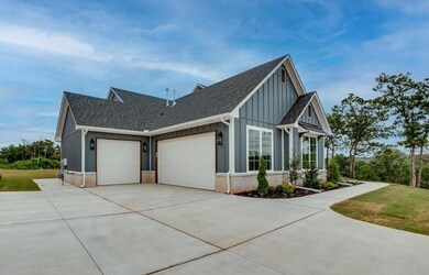 View of property exterior with an attached garage, board and batten siding, concrete driveway, roof with shingles, and brick siding