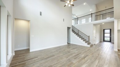 Unfurnished living room with a high ceiling, stai
