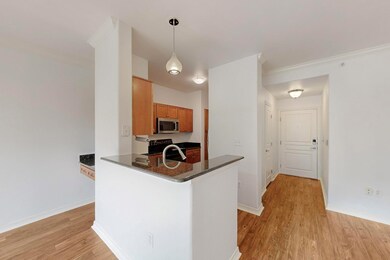 Kitchen featuring dark countertops, brown cabinetr