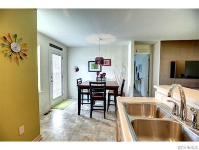 Open dining room/breakfast nook has a door to back