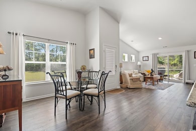Dining room with high vaulted ceiling, baseboards,