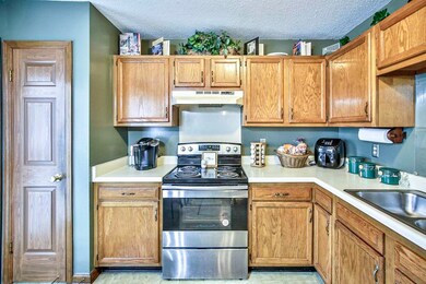 Kitchen with sink, electric range, and a textured 