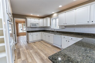Kitchen featuring laminate flooring, granite count