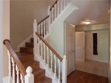 Staircase. Large tiled  foyer, half bath, coat closet and stairwell