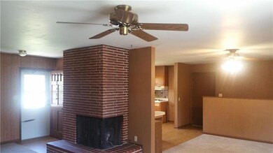 Corner fireplace in the living room, shows the din