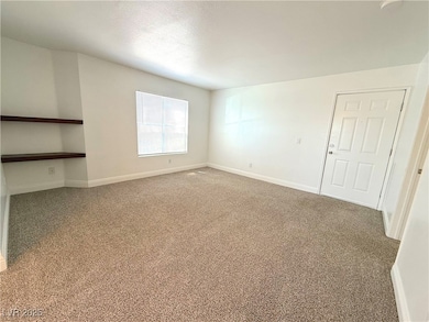 Empty room featuring carpet floors and a textured