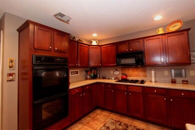 Double ovens and gas cooktop.
