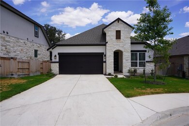 French country home featuring stone siding, an at