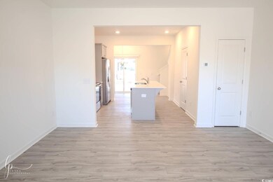 Kitchen with light wood-style flooring, baseboards, a sink, and recessed lighting